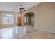 Bright living room features travertine floors, a ceiling fan, and arched entryways to other rooms at 8158 E Rita Dr, Scottsdale, AZ 85255