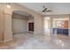 Open living room boasts travertine floors, arched doorways, and a wine rack, perfect for entertaining at 8158 E Rita Dr, Scottsdale, AZ 85255