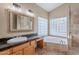 Main bathroom featuring soaking tub, granite countertops and glass block window at 8158 E Rita Dr, Scottsdale, AZ 85255