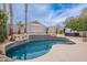Landscaped backyard pool featuring a hot tub and palm trees with privacy wall at 8158 E Rita Dr, Scottsdale, AZ 85255