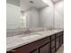 Bathroom with granite countertop, dual sinks, and vanity at 8208 W Albeniz Pl, Phoenix, AZ 85043