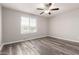 A spacious bedroom with new hardwood flooring and a ceiling fan at 8208 W Albeniz Pl, Phoenix, AZ 85043