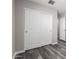 Clean bedroom features gray flooring and closet with white sliding doors at 8208 W Albeniz Pl, Phoenix, AZ 85043