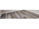 Clean bedroom features stylish gray flooring and white baseboards at 8208 W Albeniz Pl, Phoenix, AZ 85043