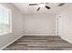 Spacious bedroom with new hardwood flooring, ceiling fan and window at 8208 W Albeniz Pl, Phoenix, AZ 85043