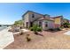 Exterior view of the home with desert landscaping in front of house at 8208 W Albeniz Pl, Phoenix, AZ 85043