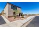View of the home's exterior with desert landscaping and a sidewalk at 8208 W Albeniz Pl, Phoenix, AZ 85043