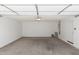 Spacious garage with concrete flooring and white walls at 8208 W Albeniz Pl, Phoenix, AZ 85043