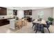 Modern kitchen with an island, dark wood cabinets, and stainless steel appliances at 8208 W Albeniz Pl, Phoenix, AZ 85043
