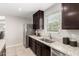 Bright kitchen with stainless steel appliances, granite countertops and dark cabinets at 8208 W Albeniz Pl, Phoenix, AZ 85043