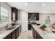 Well-lit kitchen with granite countertops, stainless steel appliances, and dark cabinets at 8208 W Albeniz Pl, Phoenix, AZ 85043