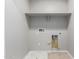 Laundry room with white shelves and hookups at 8208 W Albeniz Pl, Phoenix, AZ 85043
