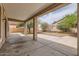 Covered back patio offers shade and outdoor living space, overlooking the landscaped backyard at 8766 W Hayward Ave, Glendale, AZ 85305