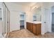 Bathroom boasts a single sink vanity, shower with glass door, and a walk-in closet at 8766 W Hayward Ave, Glendale, AZ 85305