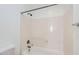 This bathroom features a bathtub with white tile walls, shower and faucet at 8766 W Hayward Ave, Glendale, AZ 85305