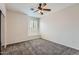 Cozy bedroom with carpet, a ceiling fan, and a charming window nook at 8766 W Hayward Ave, Glendale, AZ 85305