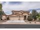 Charming two-story home features a three-car garage, desert landscaping, and a tile roof at 8766 W Hayward Ave, Glendale, AZ 85305
