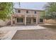 Two-story home features a covered back patio and a mix of gravel and grass in the backyard at 8766 W Hayward Ave, Glendale, AZ 85305