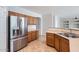 Bright kitchen features stainless steel appliances, wood cabinets, and tile floors at 8766 W Hayward Ave, Glendale, AZ 85305