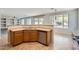 View of the open-concept kitchen, featuring tile floor, breakfast bar, and stainless steel dishwasher at 8766 W Hayward Ave, Glendale, AZ 85305
