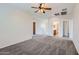 Spacious living room features neutral carpet, ceiling fan and a staircase at 8766 W Hayward Ave, Glendale, AZ 85305