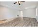 Bright and open living room area showing tile and wood-look flooring and ceiling fan at 8766 W Hayward Ave, Glendale, AZ 85305