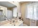 Well-lit bathroom featuring a vanity and a shower at 10137 W Forrester Dr, Sun City, AZ 85351