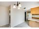 Dining area with tile flooring, chandelier lighting, and an open layout to the kitchen at 10137 W Forrester Dr, Sun City, AZ 85351