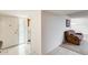 Hallway leading to a living room with a large sofa at 10137 W Forrester Dr, Sun City, AZ 85351