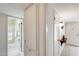 Hallway view of bathroom with tile floors, shower, and storage cabinets at 10137 W Forrester Dr, Sun City, AZ 85351
