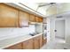 View of the kitchen area featuring tiled floor, wooden cabinets, and white countertops at 10137 W Forrester Dr, Sun City, AZ 85351