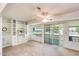 Bright living room featuring built-in shelving, a ceiling fan, and a sliding glass door at 10137 W Forrester Dr, Sun City, AZ 85351