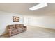 Cozy living room with plush sofa, carpet, and ample natural light offers a comfortable retreat at 10137 W Forrester Dr, Sun City, AZ 85351