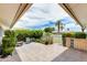 Welcoming covered patio with desert landscaping, brick accents, and comfortable outdoor seating at 10137 W Forrester Dr, Sun City, AZ 85351