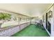 Covered patio with green carpeting overlooking a well-manicured lawn at 10137 W Forrester Dr, Sun City, AZ 85351