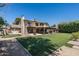 Beautiful backyard with manicured lawn, covered patio, and two-story home exterior at 10759 N 101St St, Scottsdale, AZ 85260