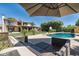 Outdoor seating area overlooking a pool and lush backyard with manicured landscaping at 10759 N 101St St, Scottsdale, AZ 85260
