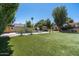 Spacious backyard with a pool, putting green, and mature landscaping at 10759 N 101St St, Scottsdale, AZ 85260