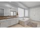 Bright bathroom features a soaking tub and vanity with granite counters, offering a relaxing retreat at 10759 N 101St St, Scottsdale, AZ 85260
