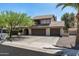 Two-story home with a three-car garage and a well-maintained front yard, offering classic curb appeal at 10759 N 101St St, Scottsdale, AZ 85260