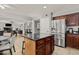 Well-lit kitchen with wooden cabinets, granite counters, stainless steel appliances, and a central island at 10759 N 101St St, Scottsdale, AZ 85260