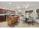 Well-lit kitchen with wooden cabinets, modern stainless steel appliances, a central island, and a cozy breakfast nook at 10759 N 101St St, Scottsdale, AZ 85260