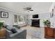 Cozy living room with fireplace, comfortable seating, plantation shutters, and abundant natural light at 10759 N 101St St, Scottsdale, AZ 85260