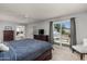 This main bedroom offers a ceiling fan and sliding doors leading to an outdoor patio with pool views at 10759 N 101St St, Scottsdale, AZ 85260