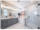 A modern bathroom with a large vanity, soaking tub, and glass-enclosed shower at 12239 W Caraveo Pl, Peoria, AZ 85383