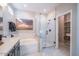A modern bathroom with a sleek vanity and glass-enclosed shower with tile surround at 12239 W Caraveo Pl, Peoria, AZ 85383