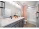 Modern bathroom features dual sinks, matte black faucets, grey cabinets and a combined tub and shower at 12239 W Caraveo Pl, Peoria, AZ 85383