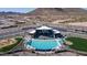 Aerial shot of the community pool, clubhouse, playground, and desert landscaping at 12239 W Caraveo Pl, Peoria, AZ 85383