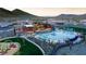 Aerial view of the community pool, clubhouse, playground, and well-manicured landscaping at 12239 W Caraveo Pl, Peoria, AZ 85383