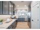 Modern kitchen features sleek, gray cabinets, stainless steel appliances, and stylish backsplash at 12239 W Caraveo Pl, Peoria, AZ 85383